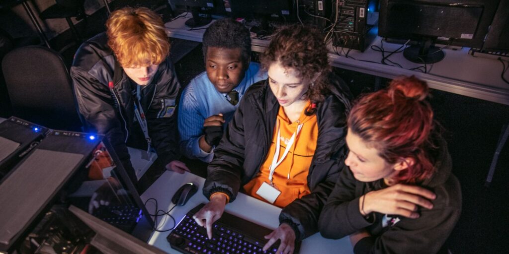 Games Jam attendees sat round computer at event