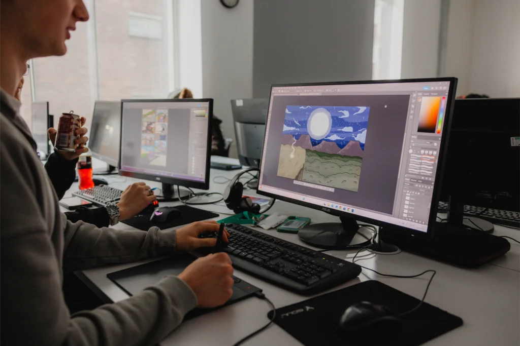 What's the difference between games art and games development? 2 Image of games art student on computer drawing his video game design